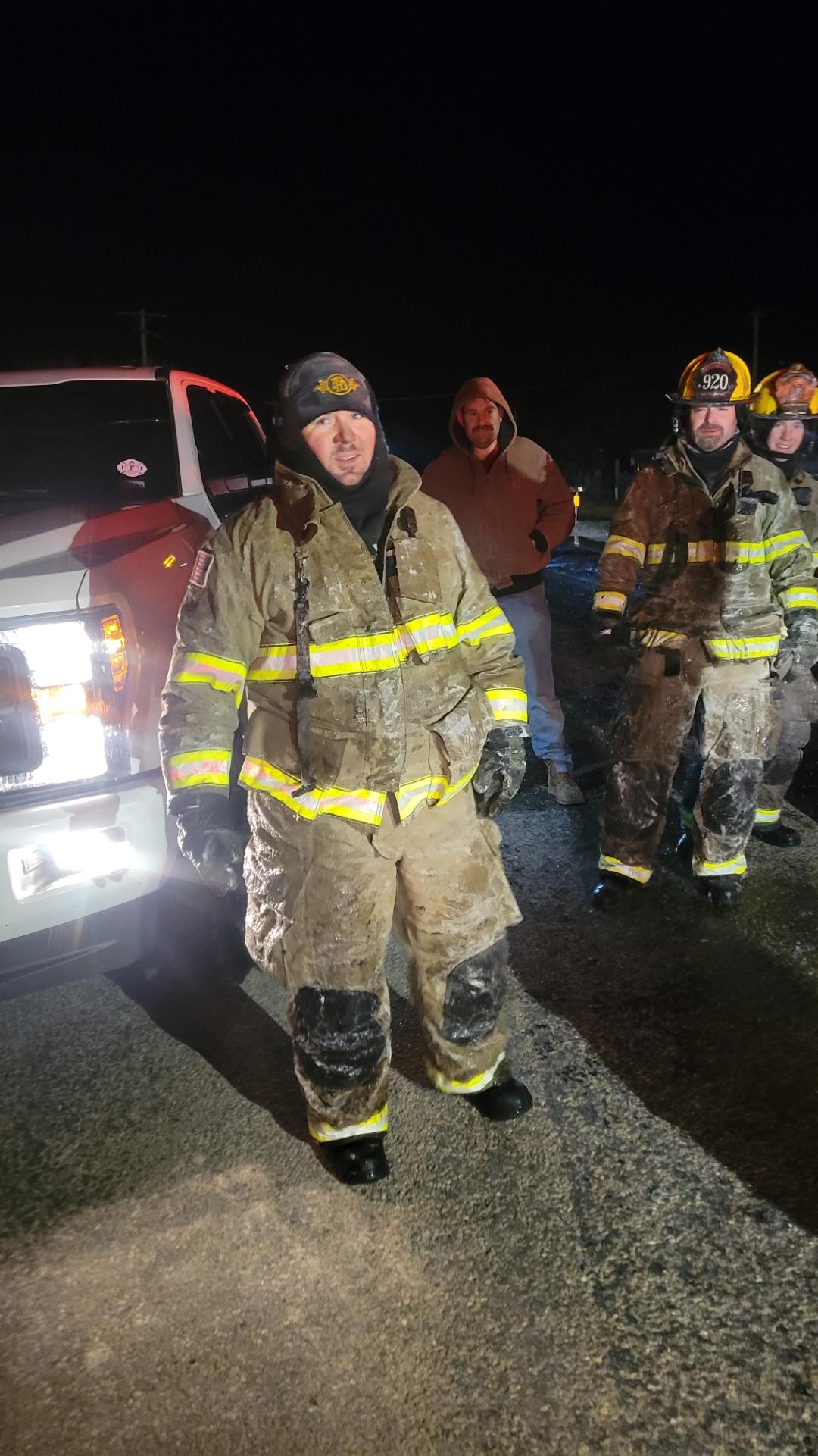 01.15.2024 Equipment Operator Shane Rowell with Firefighters Cary Smith and Caleb Wood in the backgr